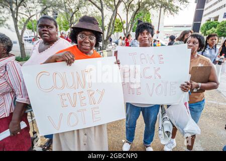 Miami Florida,Stephen P. Clark Government Center centre,Democratic Party presidential election rally,political event Black women holding signs vote co Stock Photo