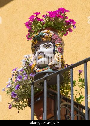 Taormina, Messina, Sicily, Italy. Low angle view of magnificent ceramic Testa di Moro flowerpot in the form of a Moor's head. Stock Photo