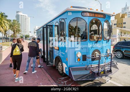 Miami Beach Florida,Indian Creek Drive,Middle Beach Loop free trolley mass transit bus stop boarding passengers riders, Stock Photo