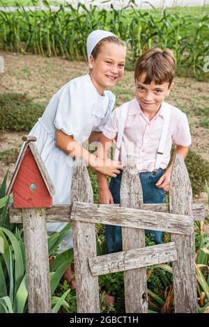 Indiana,LaGrange County,Shipshewana,Amish Farm Tour,boy girl kids children wearing suspenders,brother sister siblings smiling, Stock Photo