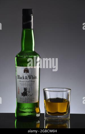 New Delhi, India. 17 June 2017:Whisky Bottle With Glass against Grey Background Stock Photo