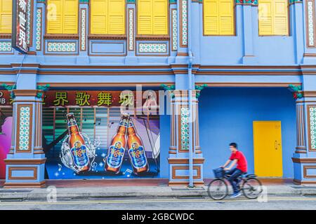 Singapore Little India Jalan Besar,street scene building,Asian teen teenager,boy bicycle bicycling rider riding,bar lounge pub nightclub club Tiger Be Stock Photo