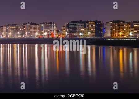 Ostend (Oostende) city skyline reflection in North Sea at night, Belgium. Stock Photo