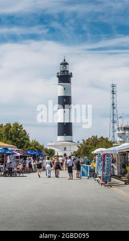 The Chassiron lighthouse with black and white stripes on blue sky, on the island of Oléron in France Stock Photo