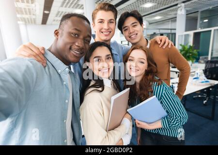 Happy international students taking selfie in university Stock Photo