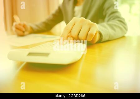 Businesswoman using calculator Stock Photo