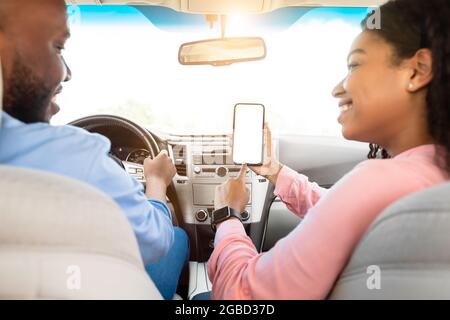 Happy African couple using showing smartphone with empty screen Stock Photo