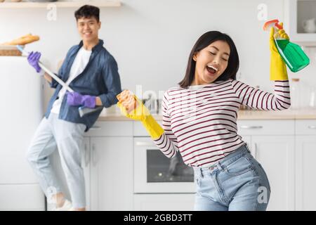 Funny asian woman singing songs and dancing Stock Photo