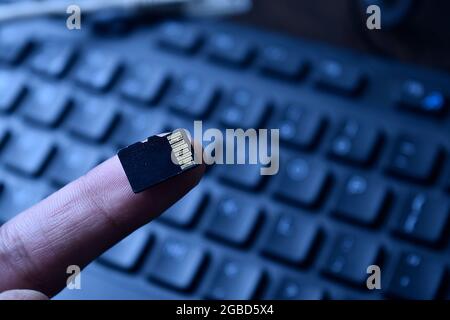 Micro SD Card on Finger Tip Stock Photo