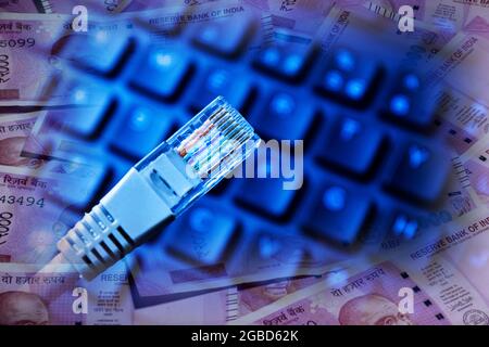 internet cable on keyboard with 2000 Indian rupees merge , online earning concept Stock Photo