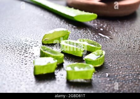 Fresh aloe vera slices on wooden table Stock Photo