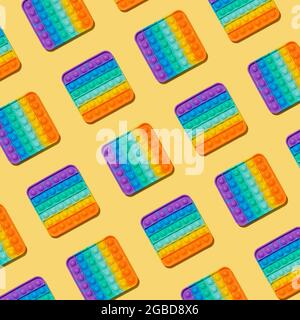 Popit pattern on yellow background. Popular silicone colorful antistress pop it toy for child. Top view. Simple dimple pattern Stock Photo