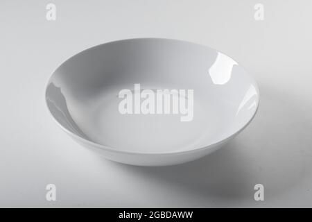 High angle of clean empty round shaped bowl placed on white background in kitchen Stock Photo