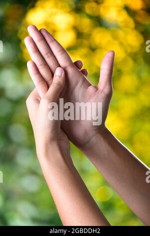 Beautiful Female Hands Make Acupressure On Outdoor Sunlight, Acupressure Alternative Therapy For Weak Eyesight and Anxiety Stock Photo