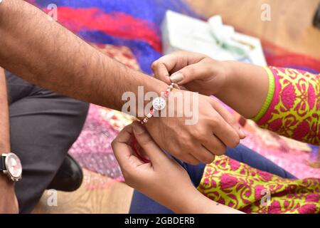 Sister Tying Rakhi on Brother's Hand on Raksha Bandhan Festival l Stock Photo