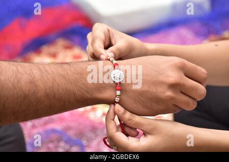 Sister Tying Rakhi On Brother's Hand Stock Photo