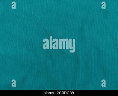 Turquoise jersey fabric matte texture top view. Blue knitwear background. Fashion color trendy clothes. Website backdrop text sign design. Abstract aq Stock Photo