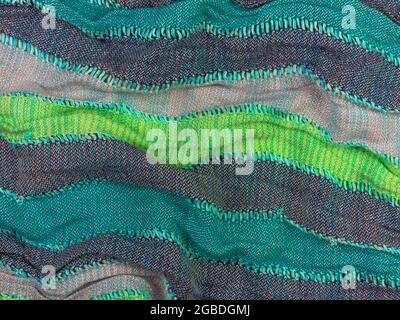 Striped knitted cotton fabric matte texture top view. Colorful stripes knitwear background. Fashion multicolor clothes trend Handmade blog backdrop te Stock Photo