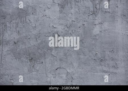 shabby gray painted concrete wall with smudges - flat background and texture. Stock Photo