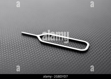 Sim Ejector Tool On Black Textured Background Stock Photo