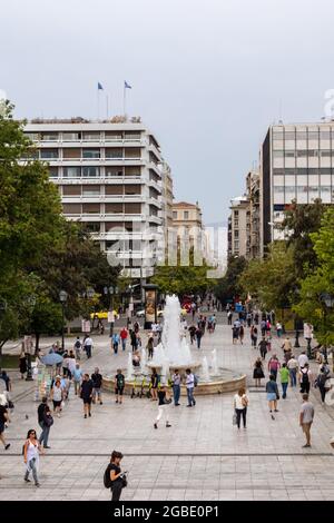Athens, Greece - September 24, 2019: Syntagma Square and fountain. City life on cloudy summer day. Plateia in central city district Stock Photo