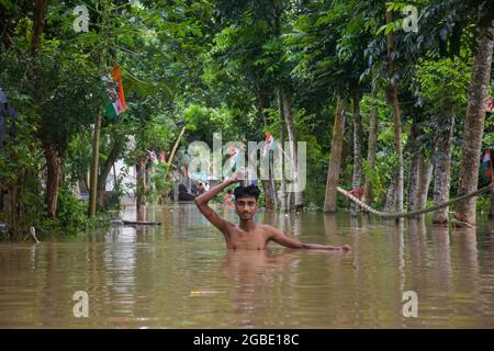 Hoogly, India. 03rd Aug, 2021. A man walks through a flooded area in West Bengal. Incessant rainfall and discharge of water from Damodar Valley Corporation dams has inundated streets and homes, at least 15 people died due to flooding and about 2.5 lakh (250000)displaced in West Bengal. Credit: SOPA Images Limited/Alamy Live News Stock Photo