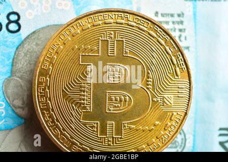 Bitcoin With Indian Currency Note Stock Photo