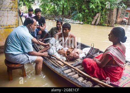 Hoogly, India. 03rd Aug, 2021. A rural medical practitioner gives medical attention to local people on a boat. Incessant rainfall and discharge of water from Damodar Valley Corporation dams has inundated streets and homes, at least 15 people died due to flooding and about 2.5 lakh (250000)displaced in West Bengal. Credit: SOPA Images Limited/Alamy Live News Stock Photo