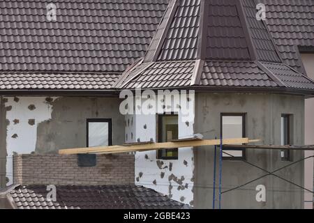 External insulation of the walls of the house with white expanded ...