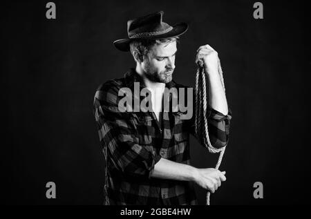 western cinema. western cowboy portrait. Wild West retro cowboy. Vintage style man. wild west rodeo. man checkered shirt on ranch. western. man in hat Stock Photo