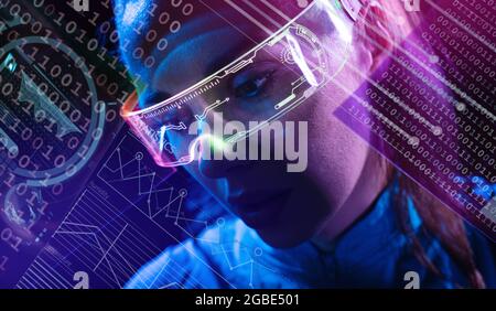 Conceptual portrait of a young woman using futuristic digital devices Stock Photo