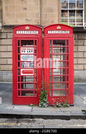 Red telephone boxes "To Let" on George IV Bridge in Edinburgh's Old Town. Stock Photo