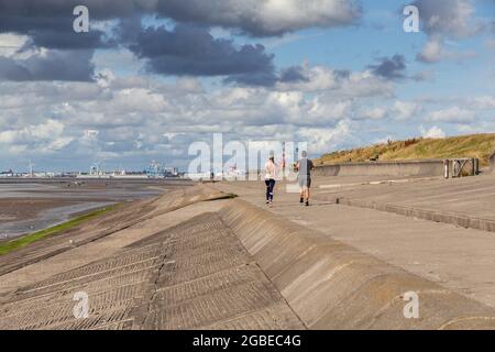 Wallasey embankment, Wirral, UK. Runners on the path alongside North Wirral Coastal Park. Stock Photo