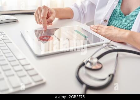close up shoot of a doctor's hands using a digital tablet Stock Photo