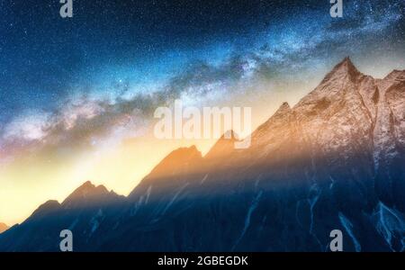 Milky Way and snowy mountains at starry night. Landscape Stock Photo