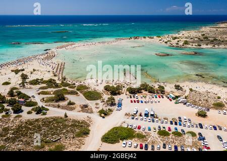 Aerial view of a beautiful but busy sandy beach and shallow lagoons surrounded by clear, blue ocean (Elafonissi, Crete,Greece) Stock Photo