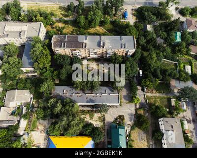 Aerial view of suburb of European city. Green neighbourhood on a sunny summer day. County living. Drone point of view Stock Photo