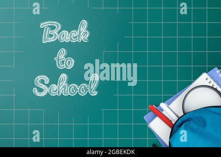 School backpack with stationery on desk. Stock Photo