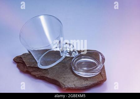 Glass mug broken by its base on slate Stock Photo