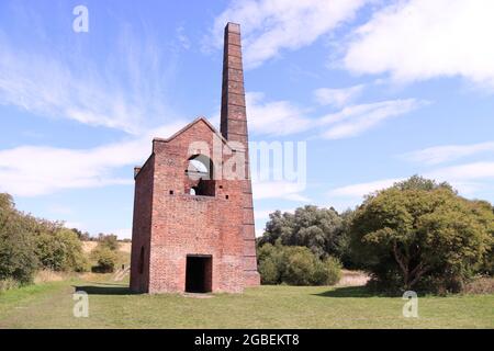 Abandoned industrial building against bright landscape Stock Photo
