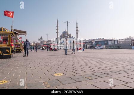 Eminonu, Istanbul, Turkey - 02.27.2021: very few people in Eminonu square in quarantine days in a sunny day Stock Photo