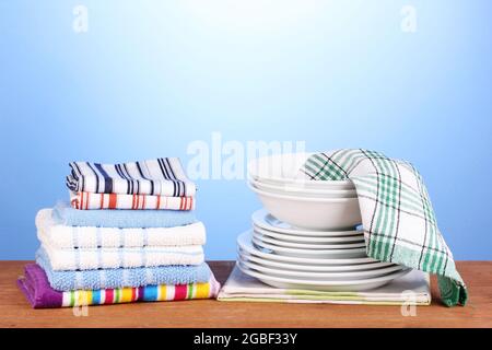 kitchen towels with dishes on blue background close-up