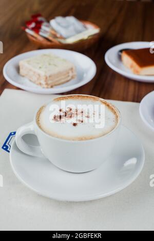 Cup of cappuccino coffee and desserts in cafeteria in Mexico City Stock Photo