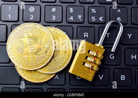 digital currency, bitcoin with padlock on keyboard, blockchain break concept Stock Photo