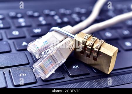 Computer internet cable and lock on keyboard, internet security concept. Stock Photo