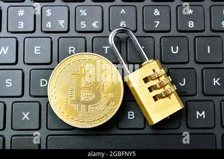 Top View Of Bitcoin With Padlock On Keyboard, Cryptocurrency Bitcoin Security Concept Stock Photo