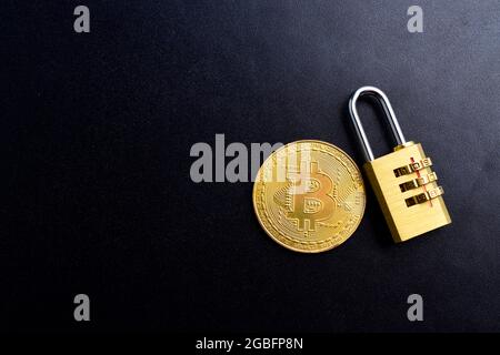 Bitcoin With Password Protected Padlock On Dark Background, Cryptocurrency Hacking Stock Photo