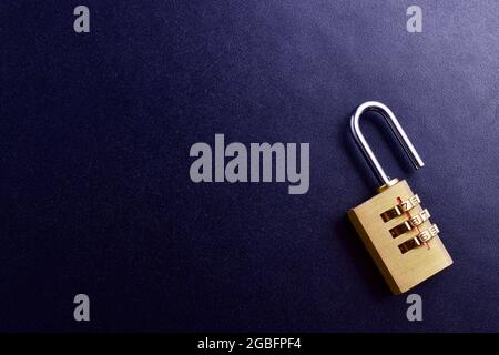 unlocked padlock on black textured background Stock Photo