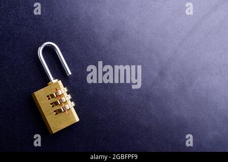 unlock padlock on black textured background Stock Photo