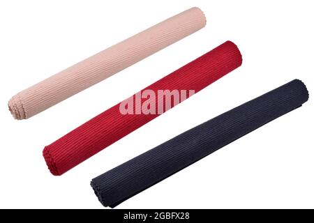 pink, red and blue place mat rolled on a white background Stock Photo